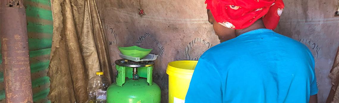 Woman cooking in a settlement in Soweto, South Africa 