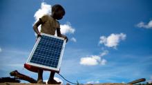 girl holding solar photovoltaic panel, image by Pawame